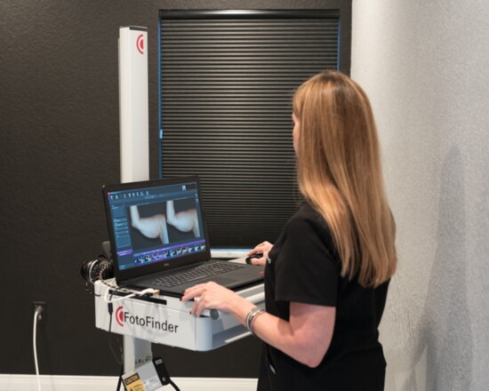 Wendy Rose examines before and after photos  of the technology used by the spa.