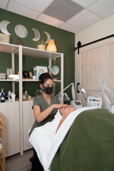 Tida Murdock gives a facial to a customer in her new salon. 