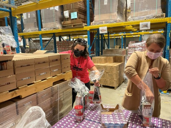 Volunteers building backpacks of food for local kids.