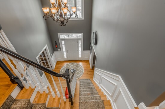 The home features an open, two-story soaring foyer and staircase. 