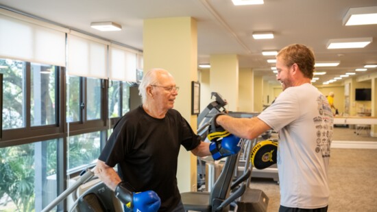 Village On The Isle resident Rudy Reinecke and boxing trainer Lee Anderson.