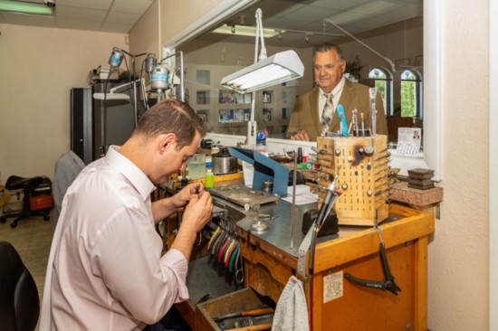 Tony Maggio III works at the jeweler's bench as his grandfather, Tony, looks on.