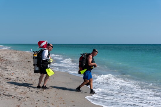 Shore divers heading into the water.