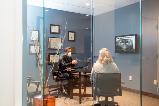 Dr. George Mantikas consults with a  patient. 